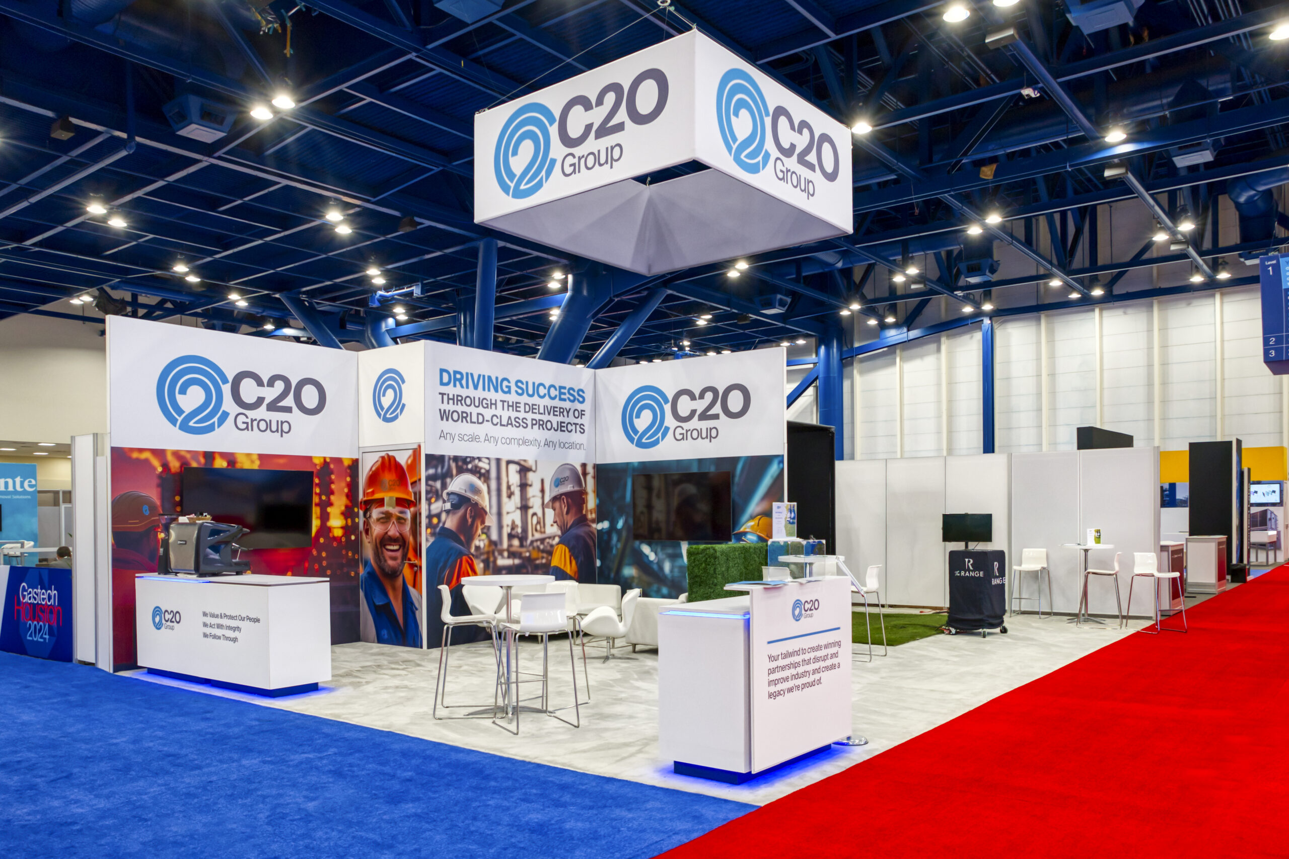 C2O Group large island rental exhibit at Gastech with hospitality and interactive golf simulator