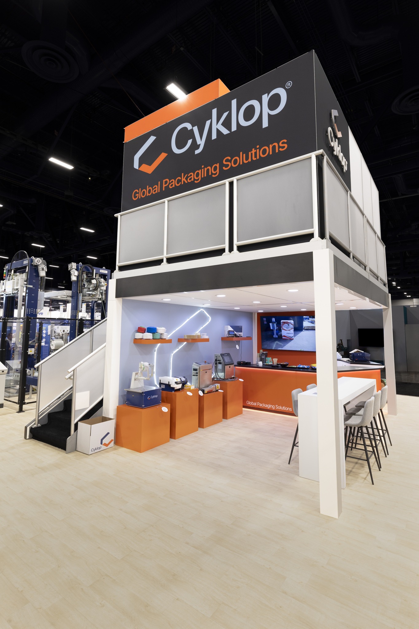 Cyklop two-story exhibit interior with hospitality counter and product displays
