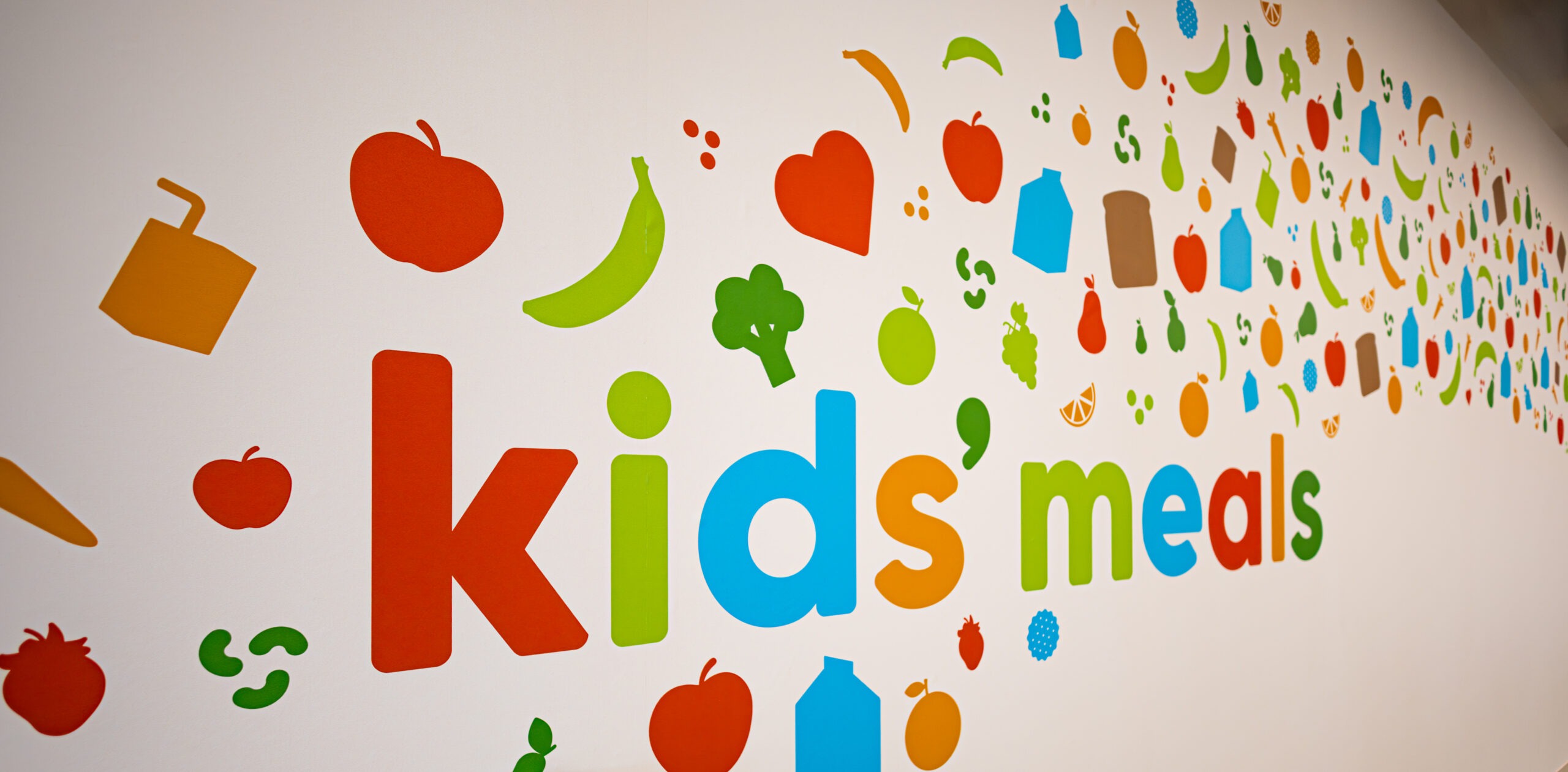 Branded Kids' Meals facility interior featuring colorful custom signage